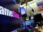 A screen displays the logo and trading information for GameStop on the floor of the New York Stock Exchange on March 29, 2022.