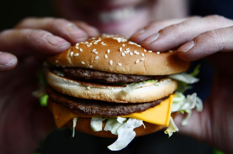 Russell Benjafield holds his Big Mac burger at a McDonald's restaurant in London, U.K., on Monday, Feb. 1, 2010. McDonald's Corp., the world's largest restaurant company, plans to increase its number of Russian outlets by 20 percent this year to capitalize on its fastest growing market in Europe. Photographer: Jason Alden/Bloomberg *** Local Caption *** Russell Benjafield