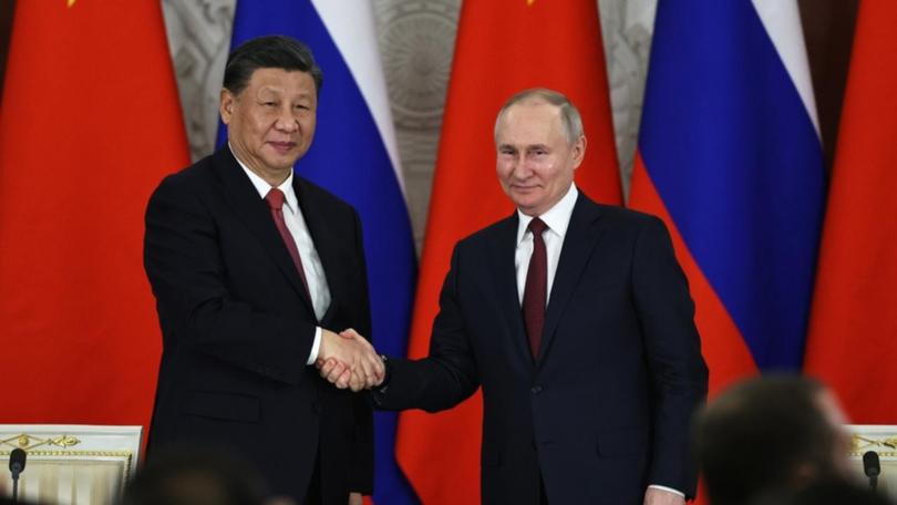 Vladimir Putin and Xi Jinping share a world view which sees the West as decadent and in decline. (AP PHOTO)