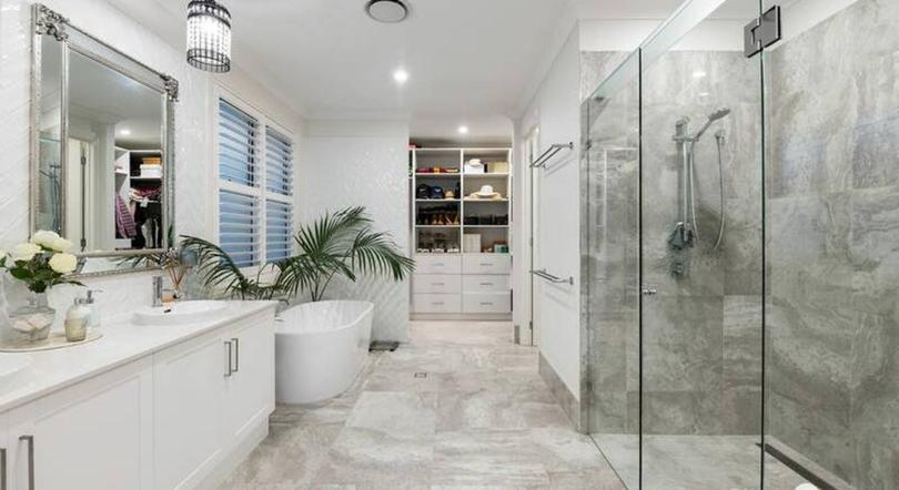 A large and luxurious bathroom complete with freestanding bath is a feature of the Hamptons style home.