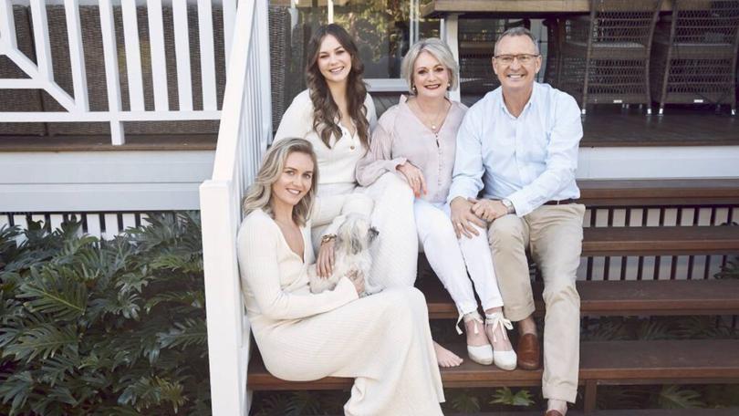 Ariarne, her younger sister Mia and parents Steve and Robyn at the family home they are now selling.