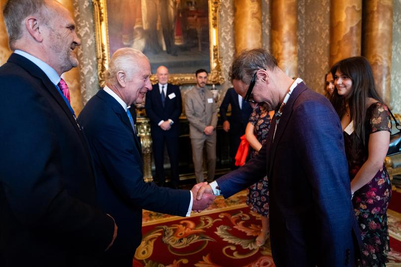 LONDON, ENGLAND - MAY 14: King Charles III greets artist Jonathan Yeo at the unveiling of the portrait of the King Charles III in the blue drawing room at Buckingham Palace on May 14, 2024 in London, England. The portrait was commissioned in 2020 to celebrate the then Prince of Wales's 50 years as a member of The Drapers' Company in 2022. The artwork depicts the King wearing the uniform of the Welsh Guards, of which he was made Regimental Colonel in 1975. The canvas size - approximately 8.5 by 6.5 feet when framed - was carefully considered to fit within the architecture of Drapers' Hall and the context of the paintings it will eventually hang alongside. Jonathan Yeo had four sittings with the King, beginning when he was Prince of Wales in June 2021 at Highgrove, and later at Clarence House. The last sitting took place in November 2023 at Clarence House. Yeo also worked from drawings and photographs he took, allowing him to work on the portrait in his London studio between sittings. (Photo by Aaron Chown-WPA Pool/Getty Images)