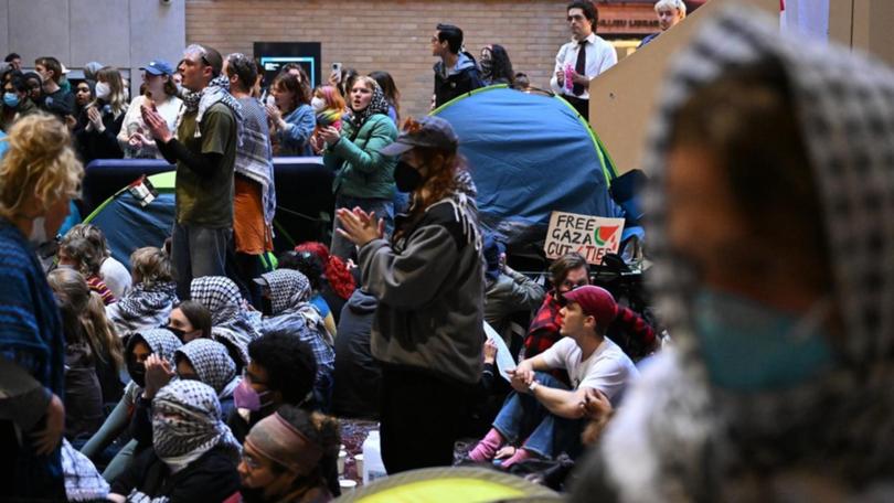 Pro-Palestine demonstrators at the University of Melbourne have taken their protest indoors. (James Ross/AAP PHOTOS)