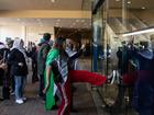 Pro-Palestine protesters kick the main entrance the ALP Conference occurs inside. NCA NewsWire / Diego Fedele