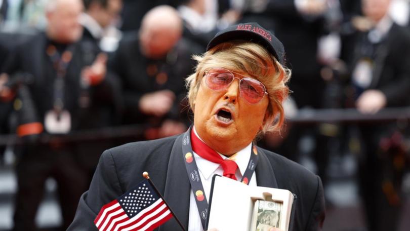 A Donald Trump impersonator took to the red carpet at The Apprentice's premiere in Cannes. (EPA PHOTO)