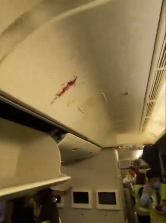 Blood stains pictured inside the plane after the turbulence.