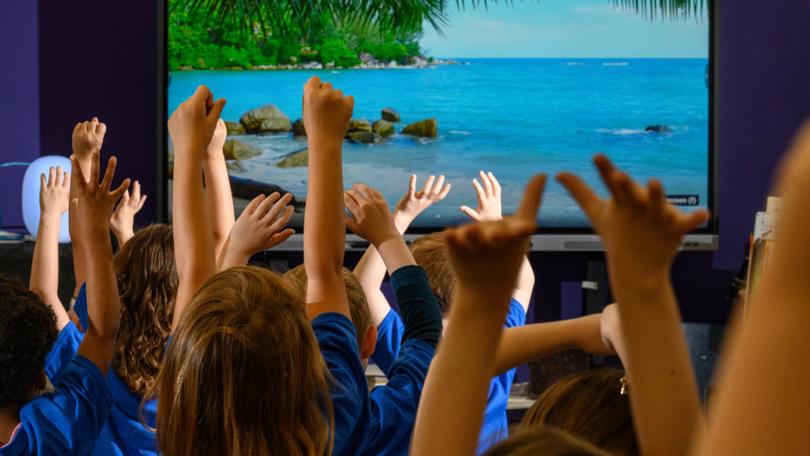 Students practice yoga during a mental health fair at Woodsdale Elementary School in Wheeling, W.Va., April 19, 2024. A Woodsdale Elementary counselor said the schools mental health fair is valuable precisely because it is universal, and troubled children are not singled out.