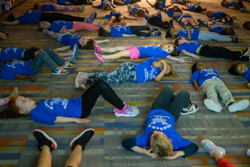Students rest after yoga during a mental health fair at Woodsdale Elementary School in Wheeling, W.Va., April 19, 2024. Woodsdale is one of many schools in the United States that have adopted mental health curriculums in recent years.