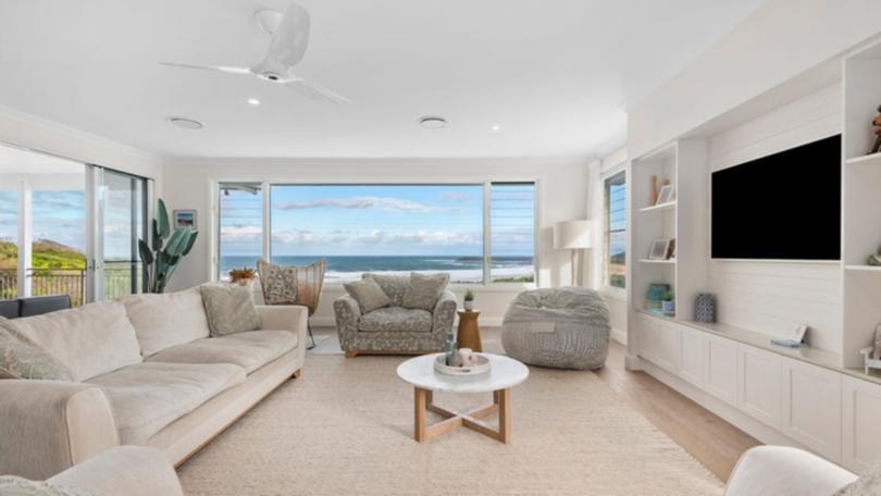 37 Surfside Drive in Catherine Hill Bay is listed with a guide of $4.8 million to $5.1 million with Nick Clarke and Taylah Clarke at Clarke and Co Estate Agents. The living room.