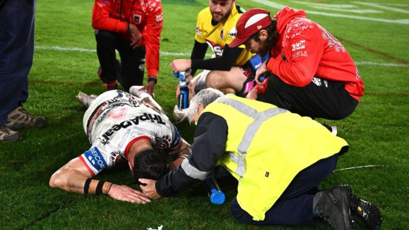 Jack Bird is left on the playing surface in agony after his ankle injury against the Dragons.
