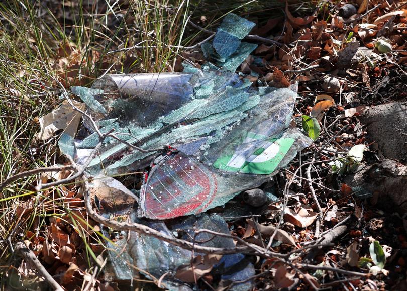 Pieces of a broken windscreen with a P-plate at the scene. 