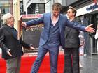 Australian filmmaker George Miller (left) and US actor Robert Downey Jr. (right) pose with Chris Hemsworth during his Walk of Fame ceremony in Hollywood.