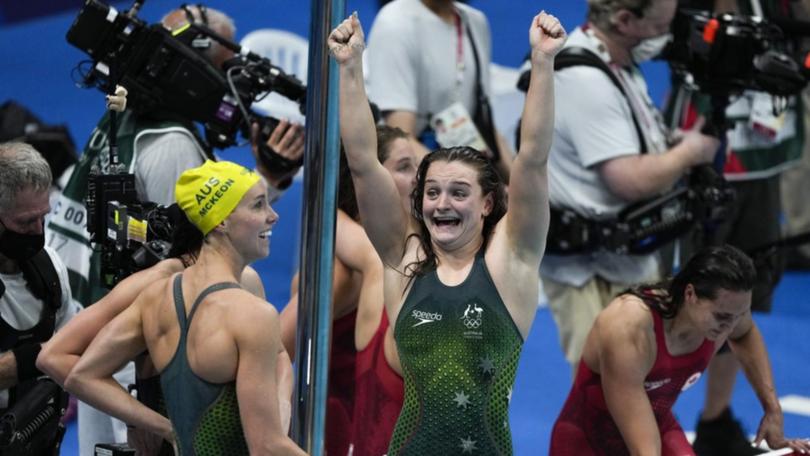 Chelsea Hodges (r) celebrates Australia's gold medal in the 4x100m medley at the Tokyo Olympics.