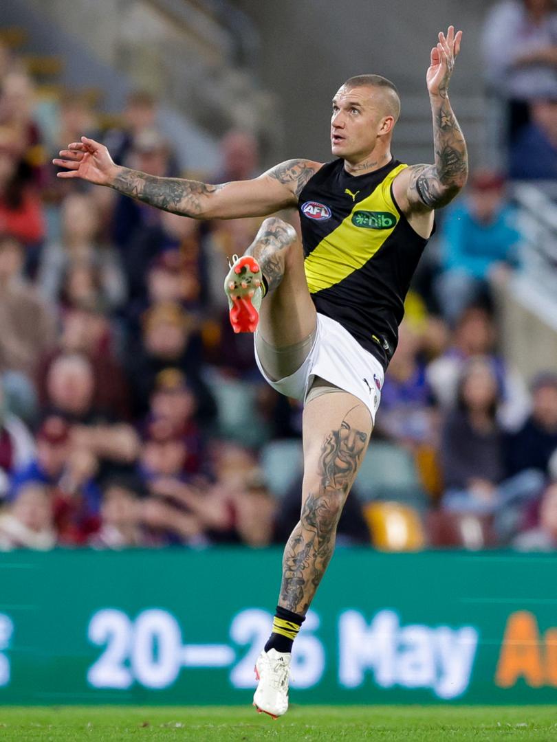 Dustin Martin kicks for goal during the Tigers’ heavy loss to Brisbane.