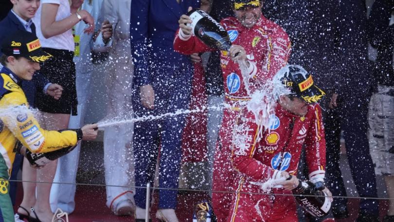 Monaco F1 winner Charles Leclerc is showered with champagne.