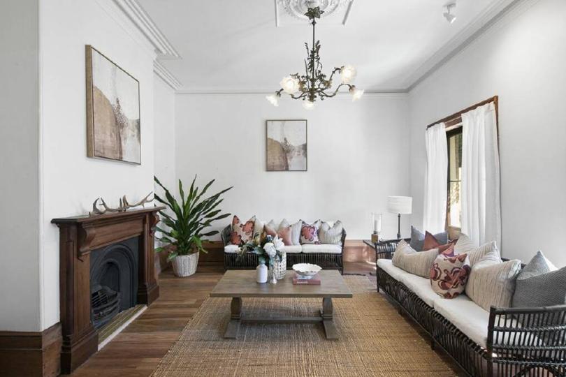 The living room has one of six original fireplaces in the house.