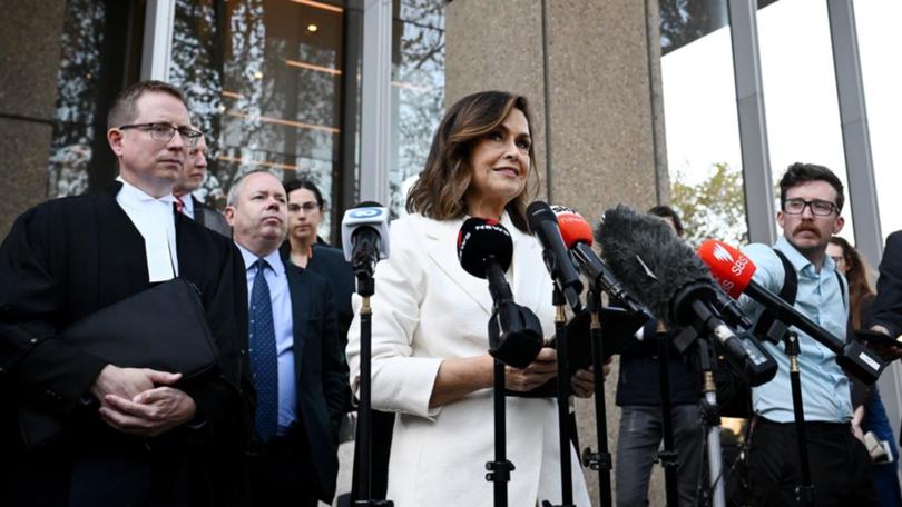 Lisa Wilkinson (centre) speaks to the media