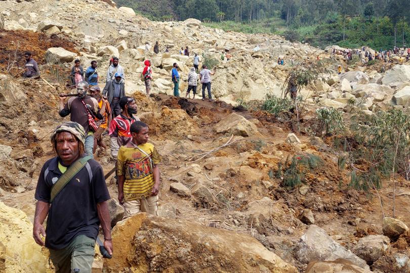 Locals gather at the site of a landslide at Mulitaka village in the region of Maip Mulitaka, in Papua New Guinea's Enga Province.