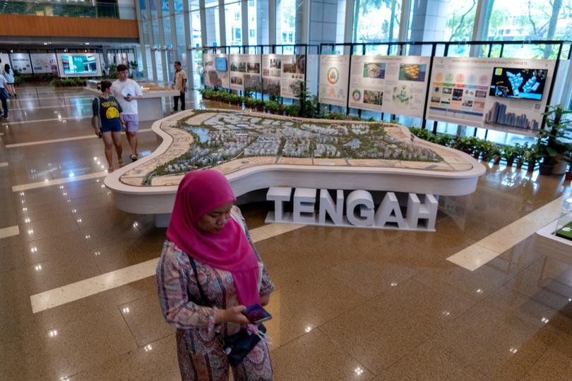 A model and displays show a public housing development plan from Singapore’s Housing and Development Board.