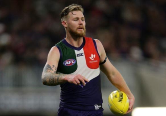 PERTH, AUSTRALIA - AUGUST 17: Cam McCarthy of the Dockers lines up a kick on goal during the 2019 AFL round 22 match between the Fremantle Dockers and the Essendon Bombers at Optus Stadium on August 17, 2019 in Perth, Australia. (Photo by Will Russell/AFL Photos)