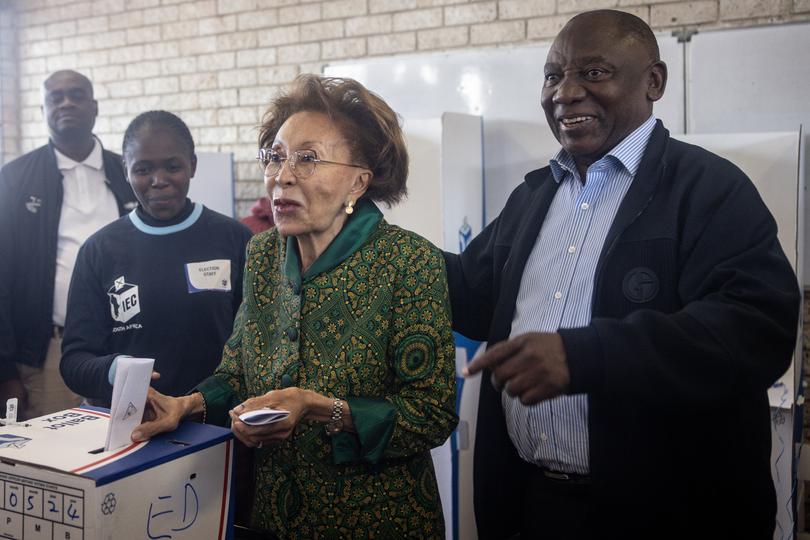 JOHANNESBURG, SOUTH AFRICA - MAY 29: President of the ruling African National Congress (ANC) and South African President, Cyril Ramaphosa assists his wife Tshepo Motsepe to cast her vote at a polling station in Soweto on May 29, 2024 in Johannesburg, South Africa. South Africa's national and provincial elections were held today to elect a new National Assembly and provincial legislature in each of the nine provinces. Results will be officially announced on June 2. (Photo by Chris McGrath/Getty Images)