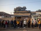 People wait in line to cast their votes in Alexandra township in Johannesburg, 