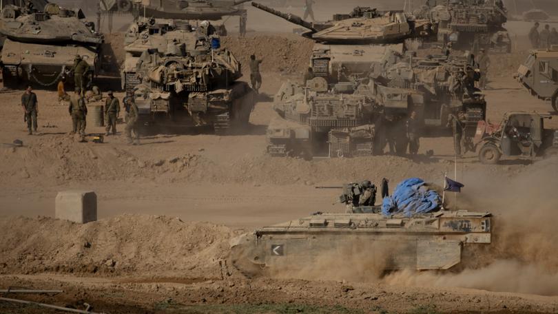 Israeli armoured personnel carriers move along the border with the Gaza Strip on May 29, 2024 in Southern Israel