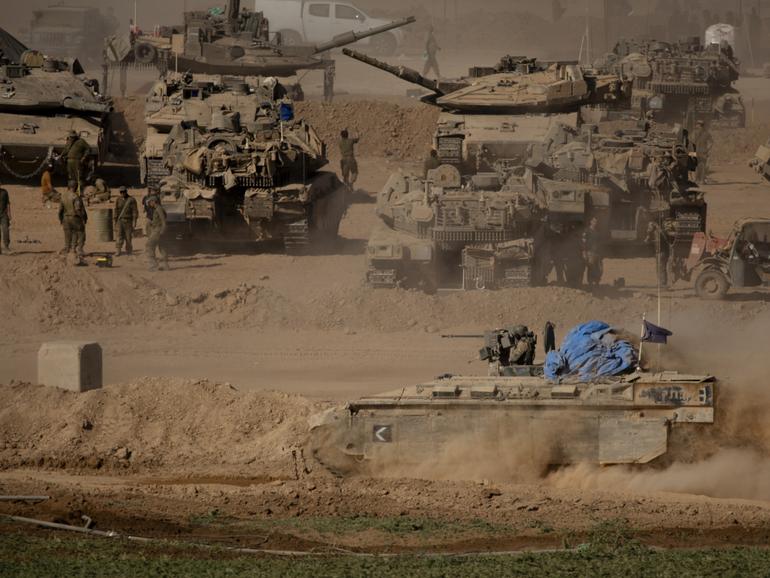 Israeli armoured personnel carriers move along the border with the Gaza Strip on May 29, 2024 in Southern Israel