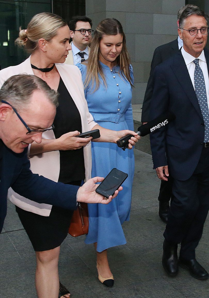 Former Liberal staffer Brittany Higgins and her former boss Senator Linda Reynolds are in mediation talks in the DMJC in Perth. PIctured - Brittany (blue dress) leaves the DMJC