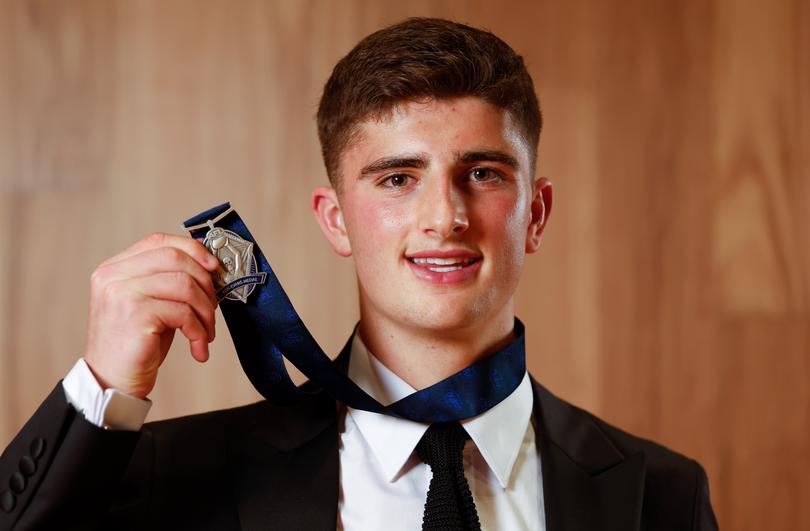 Harry Sheezel of the Kangaroos poses with the Rising Star award.