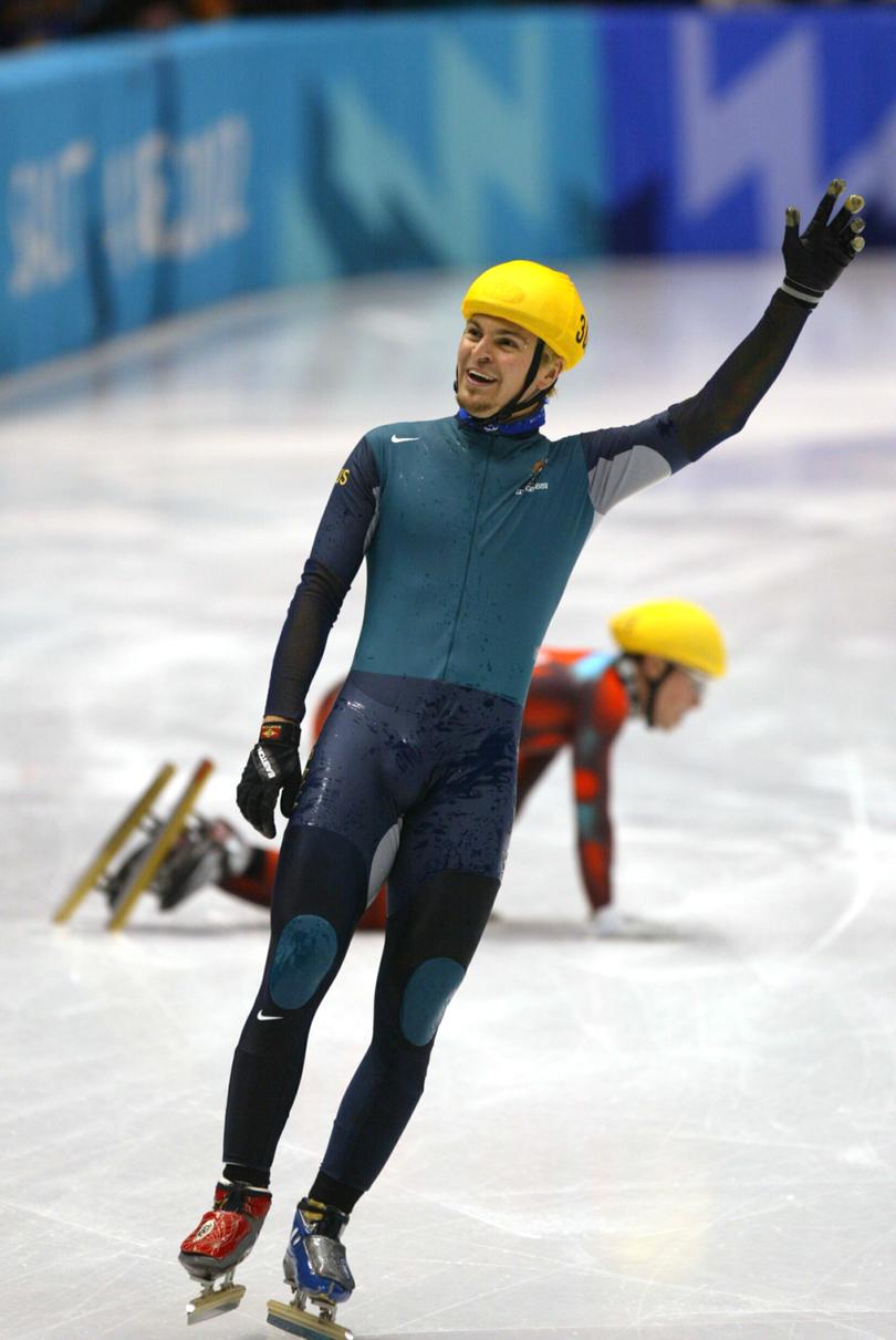 16 Feb 2002: Steven Bradbury of Australia celebrates winning the gold medal after crossing the finish line as Mathieu Turcott of Canada lies on the ice behind him.
