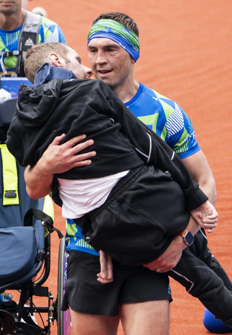 Rob Burrow and Kevin Sinfield cross the finish line of the 2023 Rob Burrow Leeds Marathon