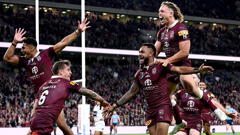 Hamiso Tabuai-Fidow celebrates with teammates after scoring a try during game two last year.