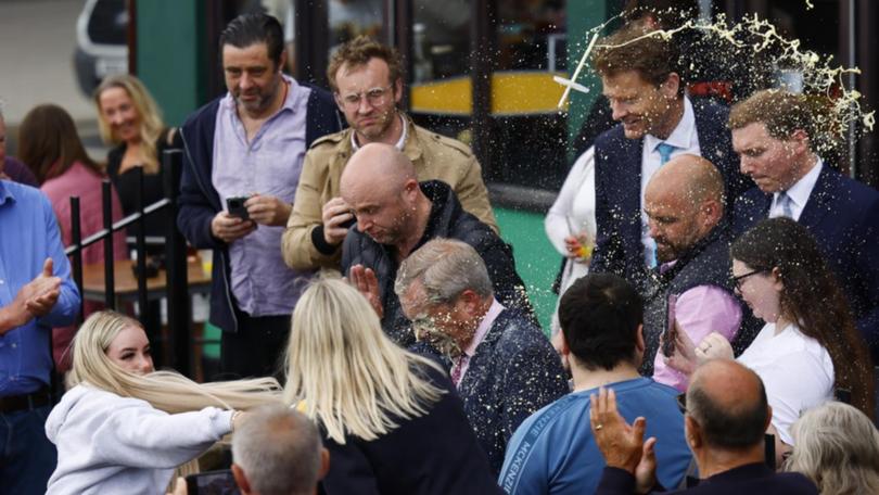 Woman throws drink at Nigel Farage