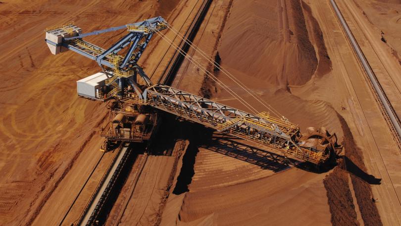 An aerial view of a reclaimer used to harvest crushed iron ore stockpiles on a mine site. Dazman