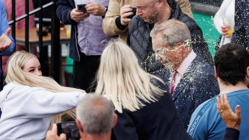 A woman accused of throwing a drink over parliamentary candidate Nigel Farage has been charged. (EPA PHOTO)