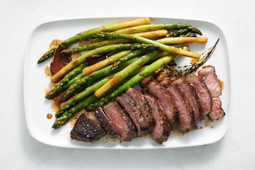 Butter-basted steak with asparagus. When this simple steak gets a quick butter baste, its centre cooks gently and evenly, and its outside develops a beautiful bronze crust sticky with ginger, garlic and herbs. 