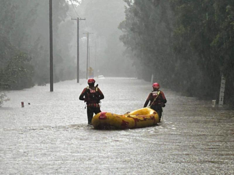 Rescue crews in action during flooding in Woollamia