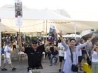 People celebrate as they hold photos of released hostages Noa Argamani and Almog Meir Jan at Tel Aviv's square.