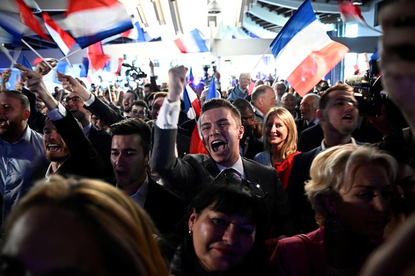 Militants celebrate at the announcement of the vote results during an evening gathering of French far-right party Rassemblement National (RN) on the final day of the European Parliament election, at the Pavillon Chesnaie du Roy in Paris, on June 9, 2024. (Photo by JULIEN DE ROSA / AFP)