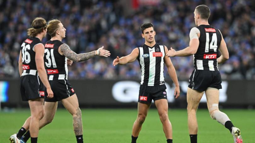 Magpie Nick Daicos (second right) kicked a goal but was injured late in the win over the Demons. (James Ross/AAP PHOTOS)