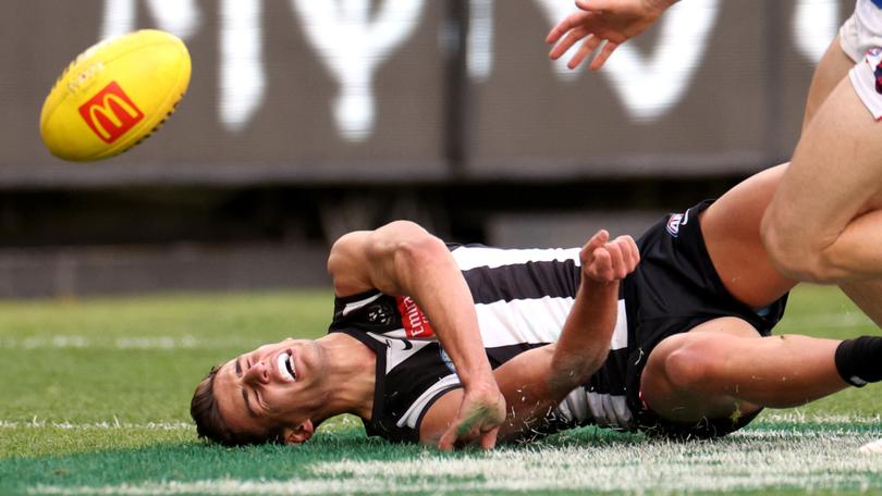 Nick Daicos goes down in the game against Melbourne.