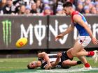 Nick Daicos goes down in the game against Melbourne.