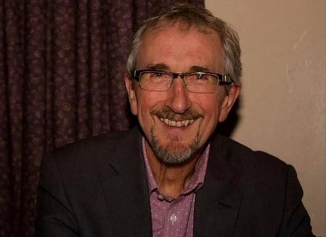 The British man who died on board a flight from London to Singapore was identified as Geoffrey Kitchen, a 73-year-old musical theatre director from Gloucestershire.