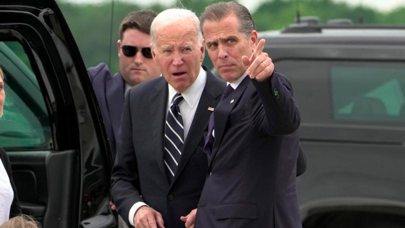 President Joe Biden talks with his son Hunter Biden as he arrives at Delaware Air National Guard Base.