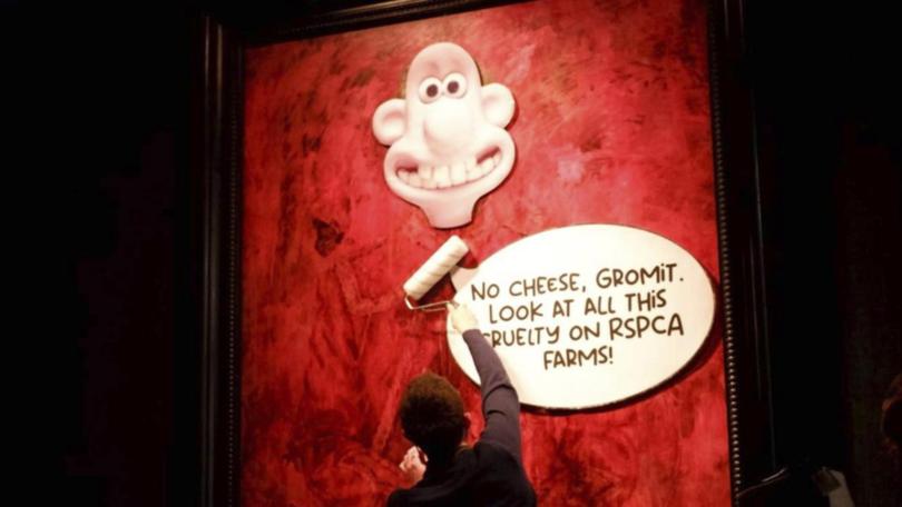 Activists stuck cartoon images on a King Charles portrait in the latest incident of art vandalism. (AP PHOTO)