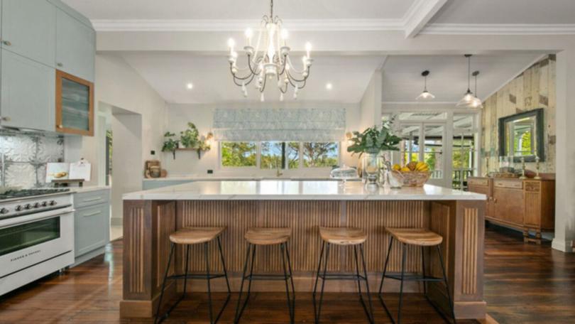 The new kitchen has fluted oak cabinetry, blue shaker doors, a 900mm cooker and an adjoining butler's pantry.