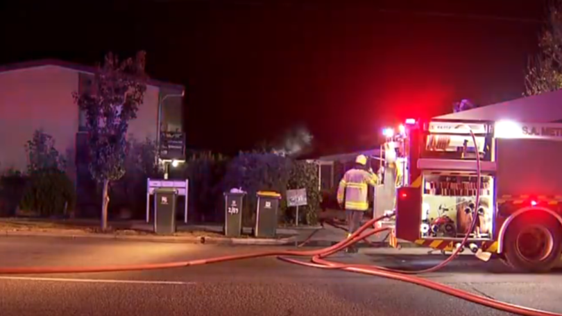 A South Australian police officer has rescued an elderly woman from her burning home and carried her to safety. 