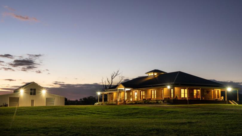 The house has an elevated position overlooking the river.