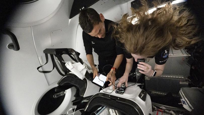 In an image provided by the company, Jared Isaacman, left, and Hayley Arceneaux, participate in SpaceXs Inspiration4 mission in September 2021. The Inspiration4 crew, who spent only three days off Earth, experienced physical and mental changes that included modest declines in cognitive tests, stressed immune systems and genetic changes within their cells. 